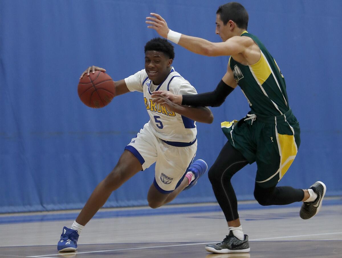 Fountain Valley's Jeremiah Davis (5), pictured driving to the basketball in a Feb. 6, 2018 game against Edison, led the Barons to a 54-53 win over Las Vegas Faith Lutheran on Wednesday.