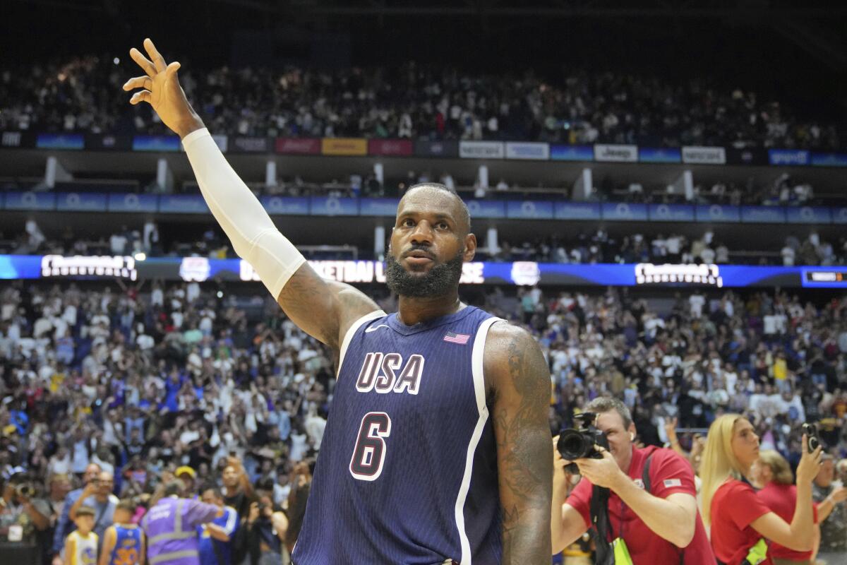 LeBron James waves to the crowd after helping Team USA defeat South Sudan in an exhibition game on Saturday in London.