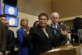 Los Angeles, California -Dec. 12, 2022-On Dec. 12, 2022, Mayor Karen Bass takes questions from the media after declaring a state of emergency against homelessness at the city's Emergency Operations Center, which will allow her to take aggressive executive actions to confront the homelessness crisis in Los Angeles. The declaration will recognize the severity of Los Angeles' crisis and break new ground to maximize the ability to urgently move people inside. From left are Supervisor Janice Hahn, Mayor Karen Bass, and Councilmember District 2 Paul Kredorian. (Carolyn Cole / Los Angeles Times)