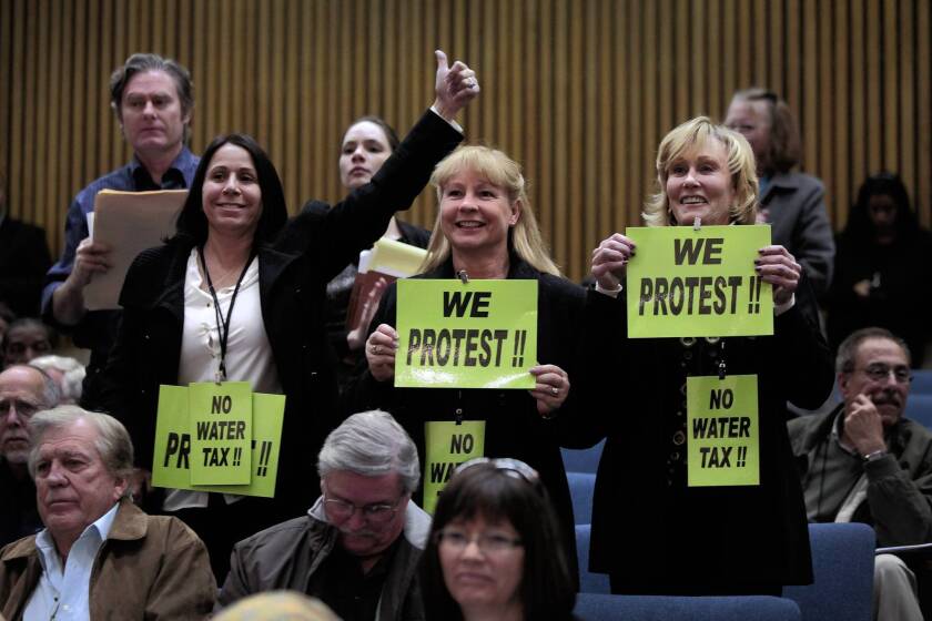 Opponents of the proposal to impose new fees on property owners to help pay for upgrades to the county's storm drain network make their feelings known at a Los Angeles County Board of Supervisors public hearing. The board extended the protest period on the issue by 60 days.