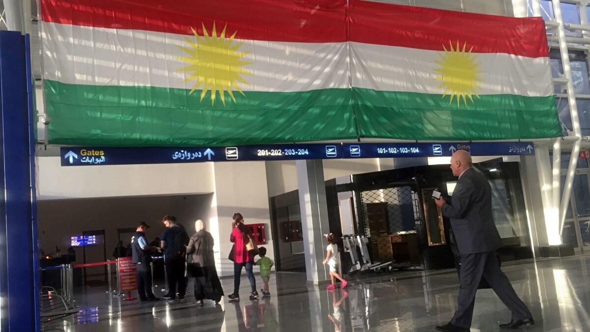 A Kurdish flag hangs in the Irbil International Airport on Wednesday. Iraq's prime minister ordered the country's Kurdish region to hand over control of its airports to federal authorities or face a flight ban.