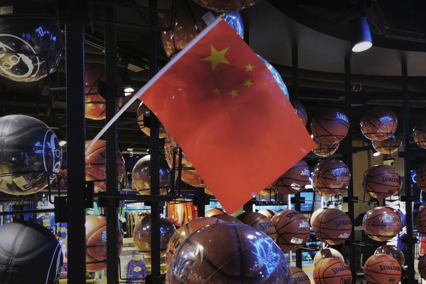 BEIJING, CHINA - OCTOBER 09: (IMAGE TAKEN WITH MOBILE PHONE CAMERA) A Chinese flag is seen placed on basketballs in the NBA flagship retail store on October 9, 2019 in Beijing, China. The NBA is trying to salvage its brand in China amid criticism of its handling of a controversial tweet that infuriated the government and has jeopardized the leagues Chinese expansion. The crisis, triggered by a Houston Rockets executives tweet that praised protests in Hong Kong, prompted the Chinese Basketball Association to suspend its partnership with the league. The backlash continued with state-owned television CCTV scrapping its plans to broadcast pre-season games in Shanghai and Shenzhen, and the cancellation of other promotional fan events. The league issued an apology, though NBA Commissioner Adam Silver angered Chinese officials further when he defended the right of players and team executives to free speech. China represents a lucrative market for the NBA, which stands to lose millions of dollars in revenue and threatens to alienate Chinese fans. Many have taken to Chinas social media platforms to express their outrage and disappointment that the NBA would question the countrys sovereignty over Hong Kong which has been mired in anti-government protests since June.(Photo by Kevin Frayer/Getty Images)