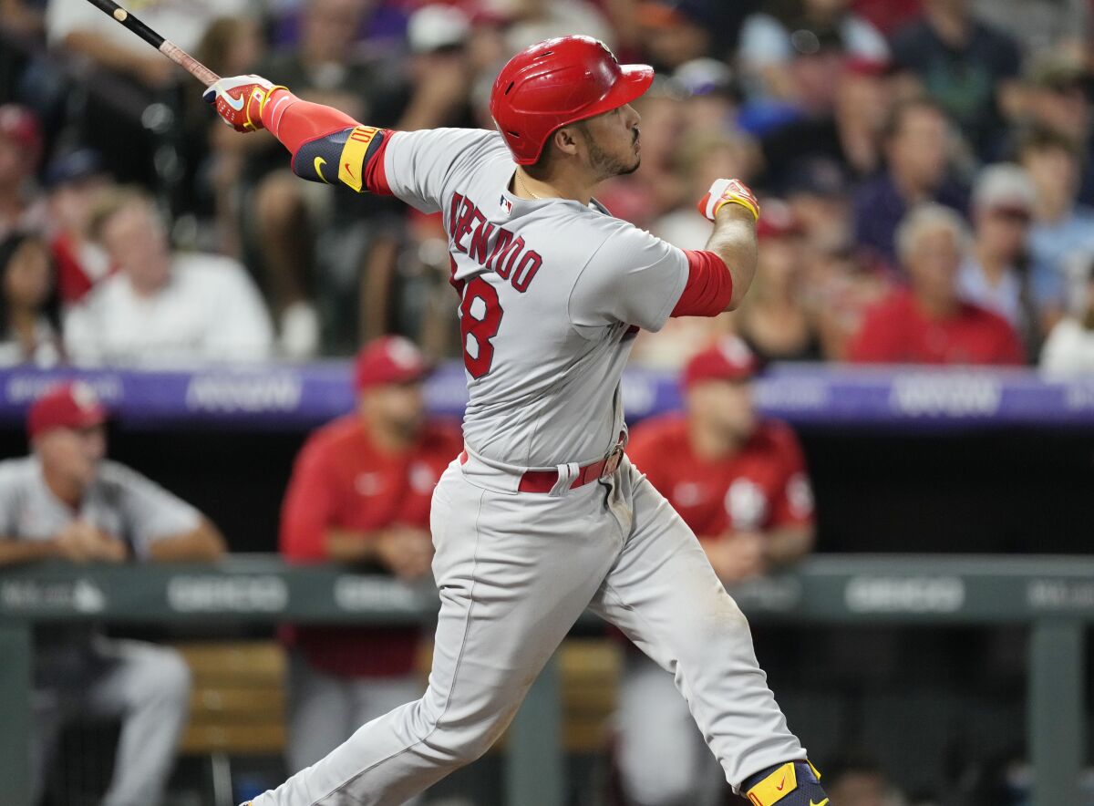 St. Louis Cardinals' Nolan Arenado watches his solo home run off Colorado Rockies relief pitcher Austin Gomber during the sixth inning of a baseball game Wednesday, Aug. 10, 2022, in Denver. (AP Photo/David Zalubowski)