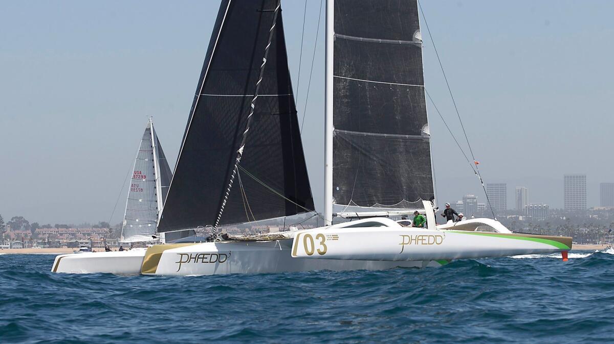 Phaedo, a tri-hull ORCA class racer, moves through the water as the crew prepares for the start in the 70th annual Newport to Ensenada International Yacht Race in Newport Beach on Friday.