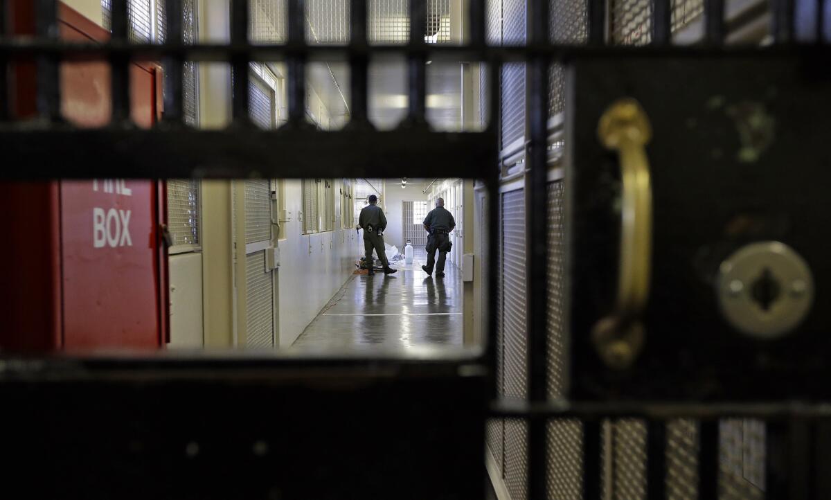 Prison guards walk down a corridor in San Quentin State Prison in San Quentin, Calif. on Dec. 29.