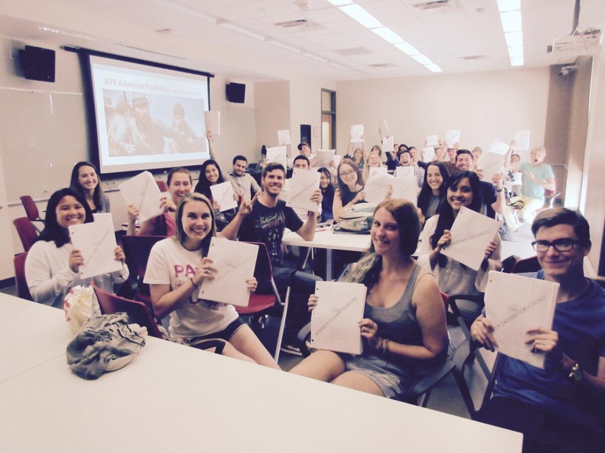 Students in the fall 2015 Advanced Production class hold up their "Free State of Jones" scripts. (University of Texas - Austin)