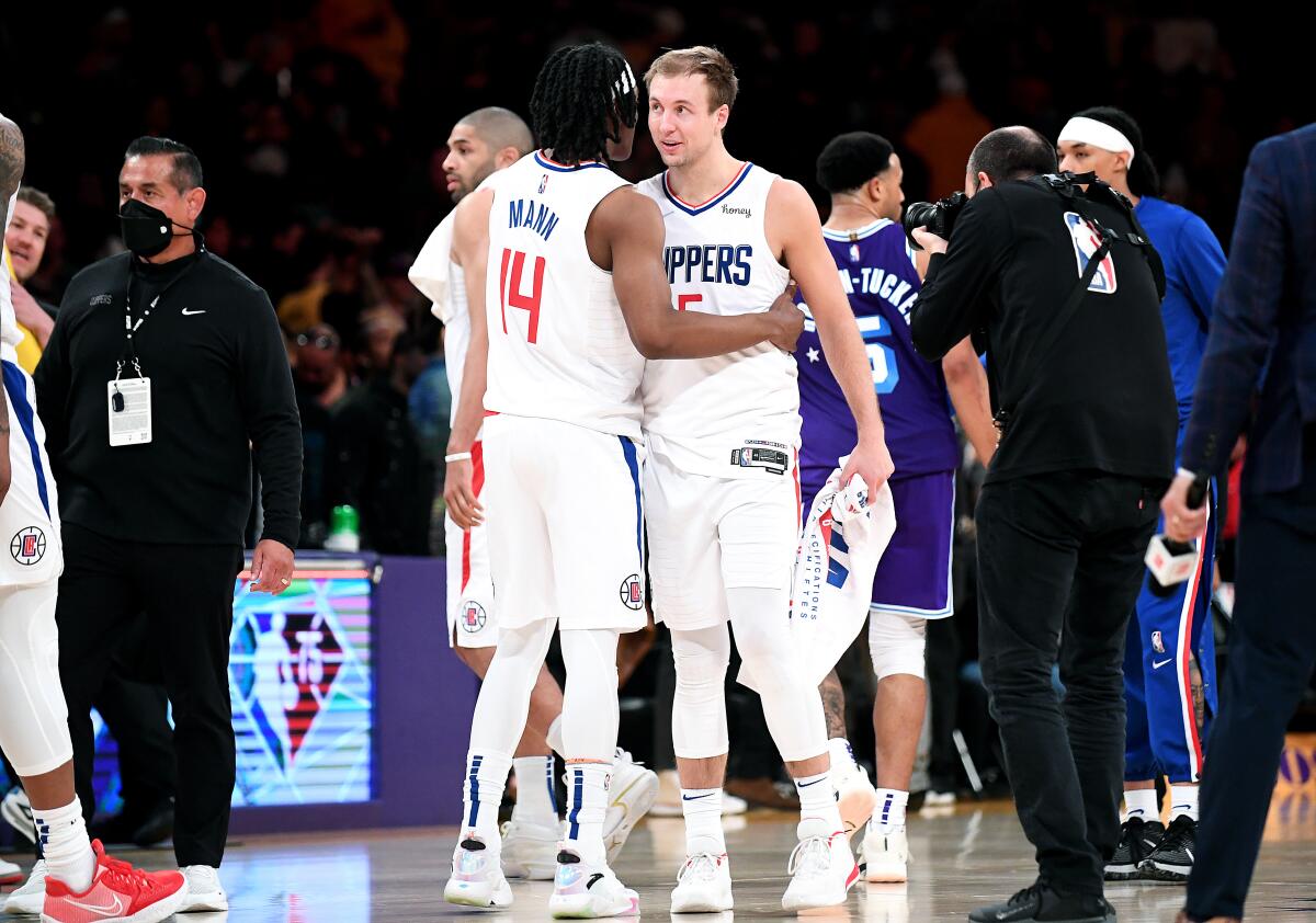 Clippers guard Terance Mann, left, and Luke Kennard celebrate their win over the Lakers.