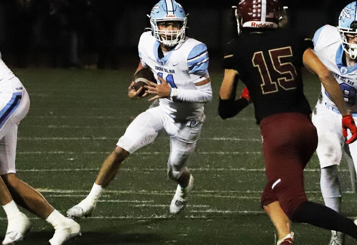 Corona del Mar quarterback Kaleb Annett runs for the first down against La Serna on Friday night at California High.