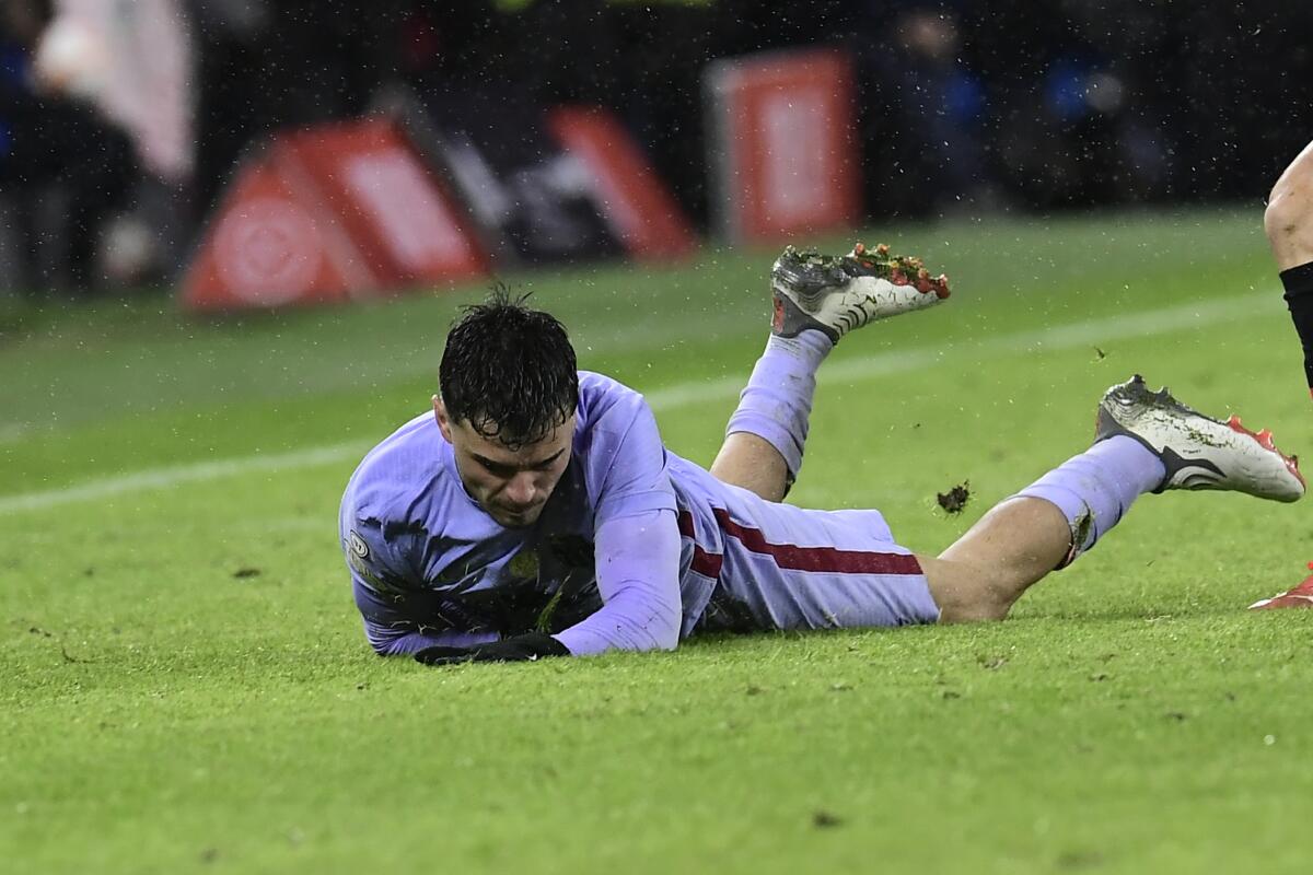 Barcelona's Pedri falls during the Spanish Copa del Rey Cup round of 16 soccer match between Athletic Club and Barcelona at the San Mames stadium in Bilbao, Friday, Jan. 21, 2022. (AP Photo/Alvaro Barrientos)