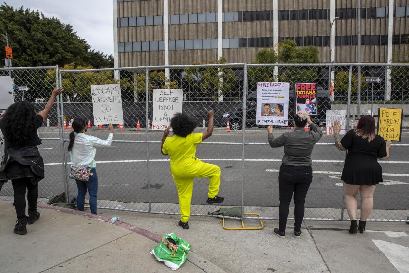 Protesters chant at limousines as they arrive for the Academy Awards at Union Station on Sunday.