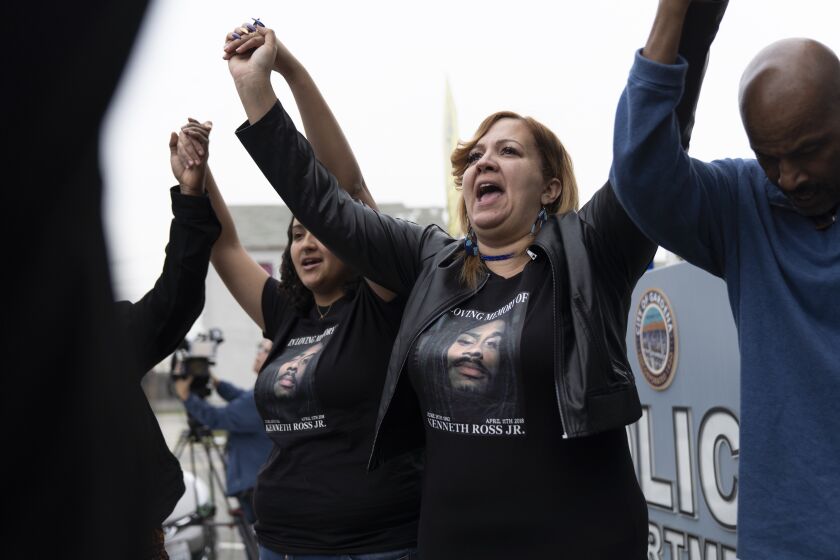 ARDENA, CA - DECEMBER 14, 2018 Fouzia Almarou, center, mother of Kenneth Ross Jr. who was killed by Gardena Police officers on April 11, 2018 prays with family and supporters following a press conference and vigil at Gardena Police headquarters this morning. The Los Angeles Civil Rights Association and family say that Gardena Police officers involved "had no reason to murder Mr. Ross Jr. except that he was African-American and a target of racial profiling." (Wesley Du / Los Angeles Times)