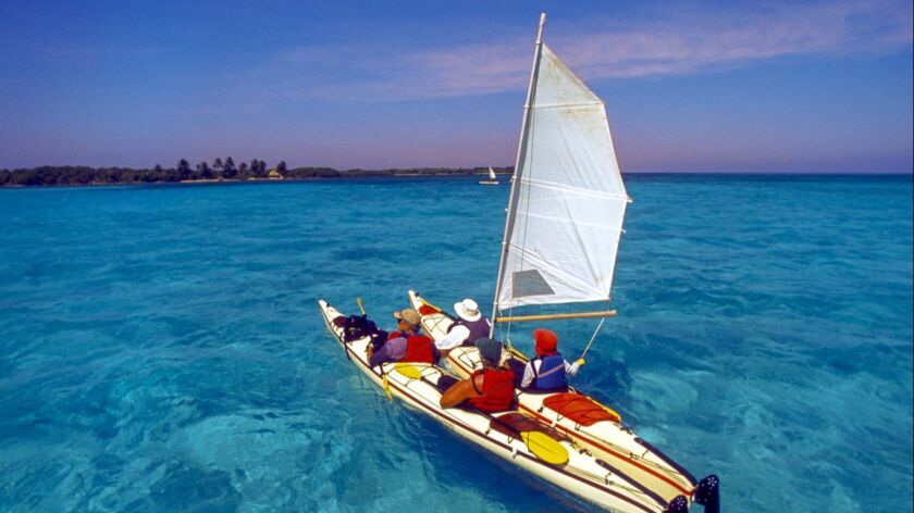 Sailing toward Long Caye, Belize, site of a family vacation built for a family's varied interests.