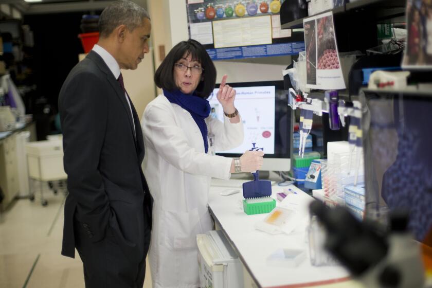 President Obama meets with Dr. Nancy Sullivan during a tour of the Vaccine Research Center at the National Institutes of Health on Tuesday in Bethesda, Md.