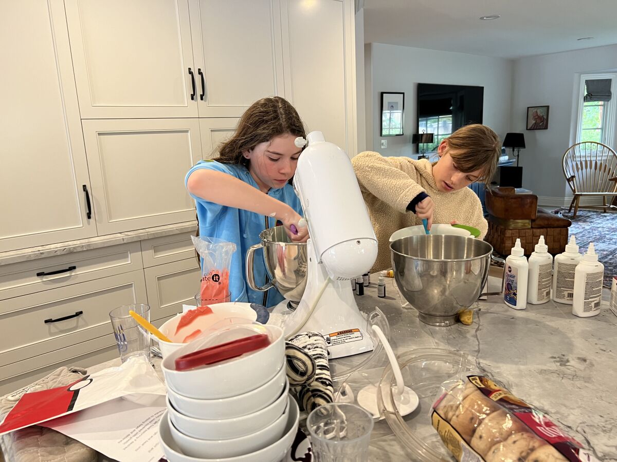 Local bakers Sophie Spear and Maggie Meier mixing up dough for their next batch of custom cookies.