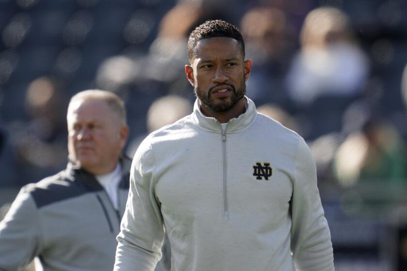 Notre Dame defensive coordinator Marcus Freeman watches during warmups before an NCAA college football game against Navy in South Bend, Ind., Saturday, Nov. 6, 2021. (AP Photo/Paul Sancya)
