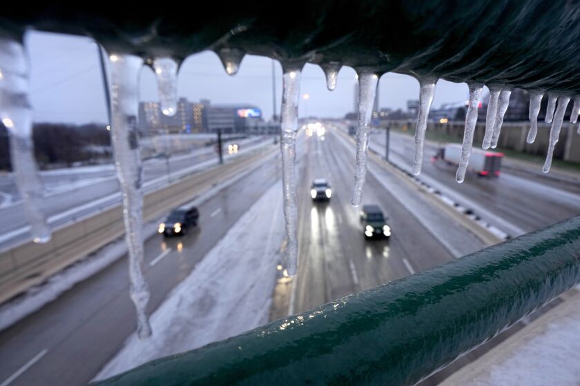 Icicles form on a rail on an overhead pass railing as drivers make their way north on US 75, Wednesday, Feb. 1, 2023, in Dallas. (AP Photo/Tony Gutierrez)