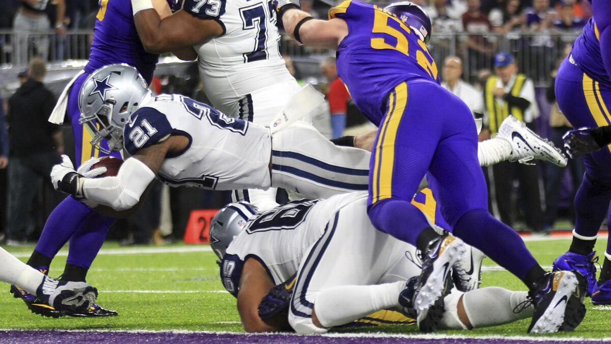 Cowboys running back Ezekiel Elliott (21) scores on a one-yard dive past Vikings linebacker Chad Greenway (52) during the first half Thursday night.