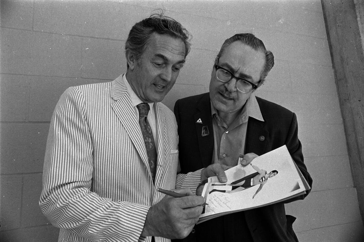 Kirk Alyn, left, who portrayed the Daily Planet's Ace reporter in the 1948 movie "Superman" and in 1950's "Atom Man vs Superman" was a guest of honor at the second annual Golden State Comic-Con held at UC San Diego's Muir College in 1971. One man who got Alyn's autograph was Forrest J. Ackerman, editor of Famous Monsters of Filmland magazine.