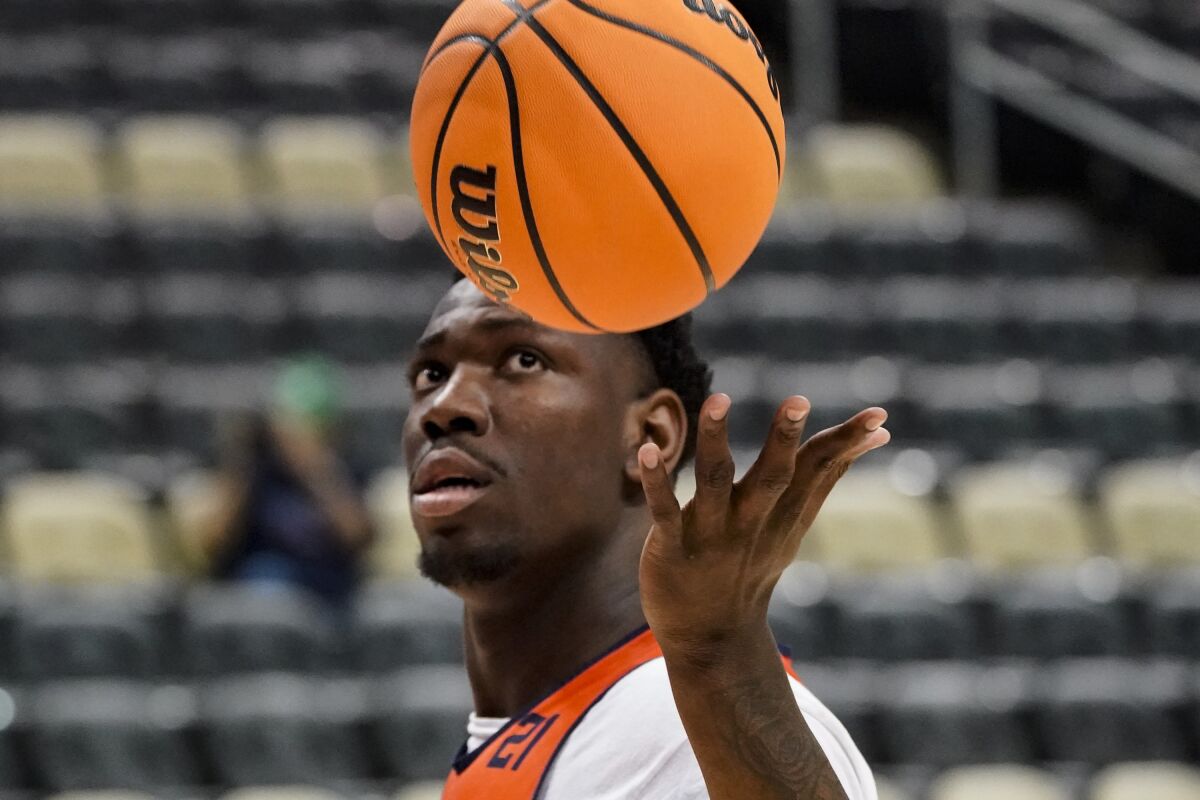 Illinois' Kofi Cockburn catches a ball as he goes into shooting drills during practice for the first round of the NCAA men's college basketball tournament, Thursday, March 17, 2022, in Pittsburgh. Illinois is to take on Chattanooga on Friday. (AP Photo/Keith Srakocic)
