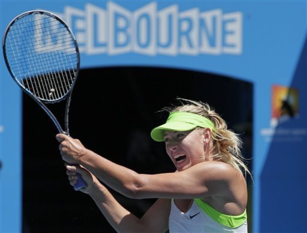 Maria Sharapova of Russia returns a ball to Jamie Hampton of the US during their second round match at the Australian Open tennis championship, in Melbourne, Australia, Thursday, Jan. 19, 2012. (AP Photo/John Donegan)