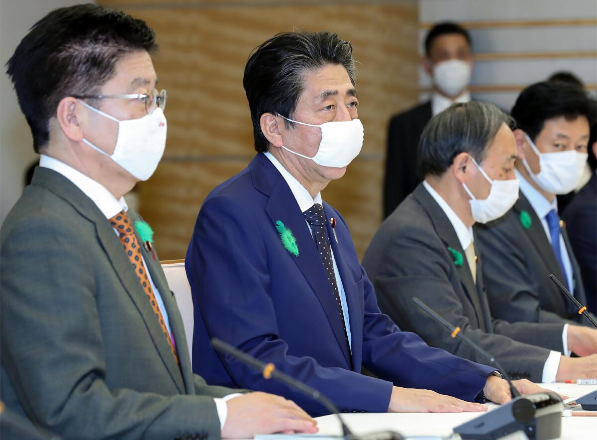 Japanese Prime Minister Shinzo Abe, second from the left, attends a meeting of a coronavirus task force in Tokyo on Thursday.