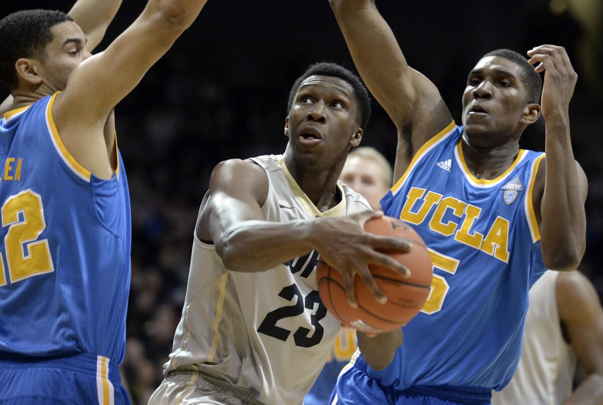 Colorado's Jaron Hopkins drives to the basket past UCLA's Noah Allen, left, and Kevon Looney. Hopkins had seven points with five rebounds and three assists in the Buffaloes' 62-56 win over the Bruins.