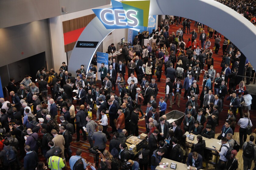 FILE - Crowds enter the convention center on the first day of the CES tech show ,Jan. 7, 2020, in Las Vegas. A long-simmering question in the tech world will finally get its answer as the influential gadget show returns to the Las Vegas Strip after a hiatus caused by the COVID-19 pandemic. The sprawling exhibition floors open Wednesday, Jan. 5, 2021 as the spread of COVID-19's omicron variant has heightened concerns about the safety of indoor events and international travel. (AP Photo/John Locher, File)