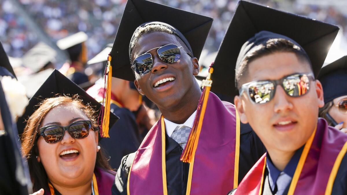 Then-Galaxy soccer star Gyasi Zardes, center, graduated from Cal State Dominguez Hills during ceremonies at the StubHub Center last year.