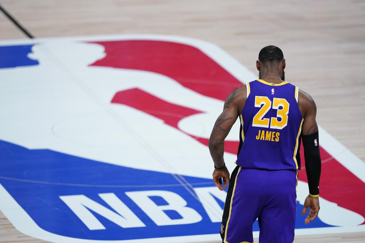Lakers star LeBron James (23) walks across the court during a playoff game against Portland.