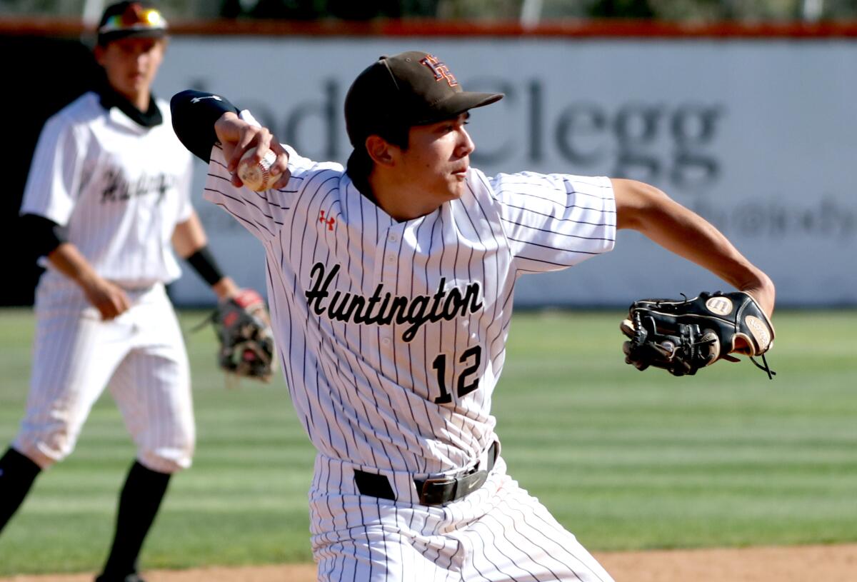 Huntington Beach's Caden Aoki throws to first base in a game vs. Edison on Wednesday, March 31.