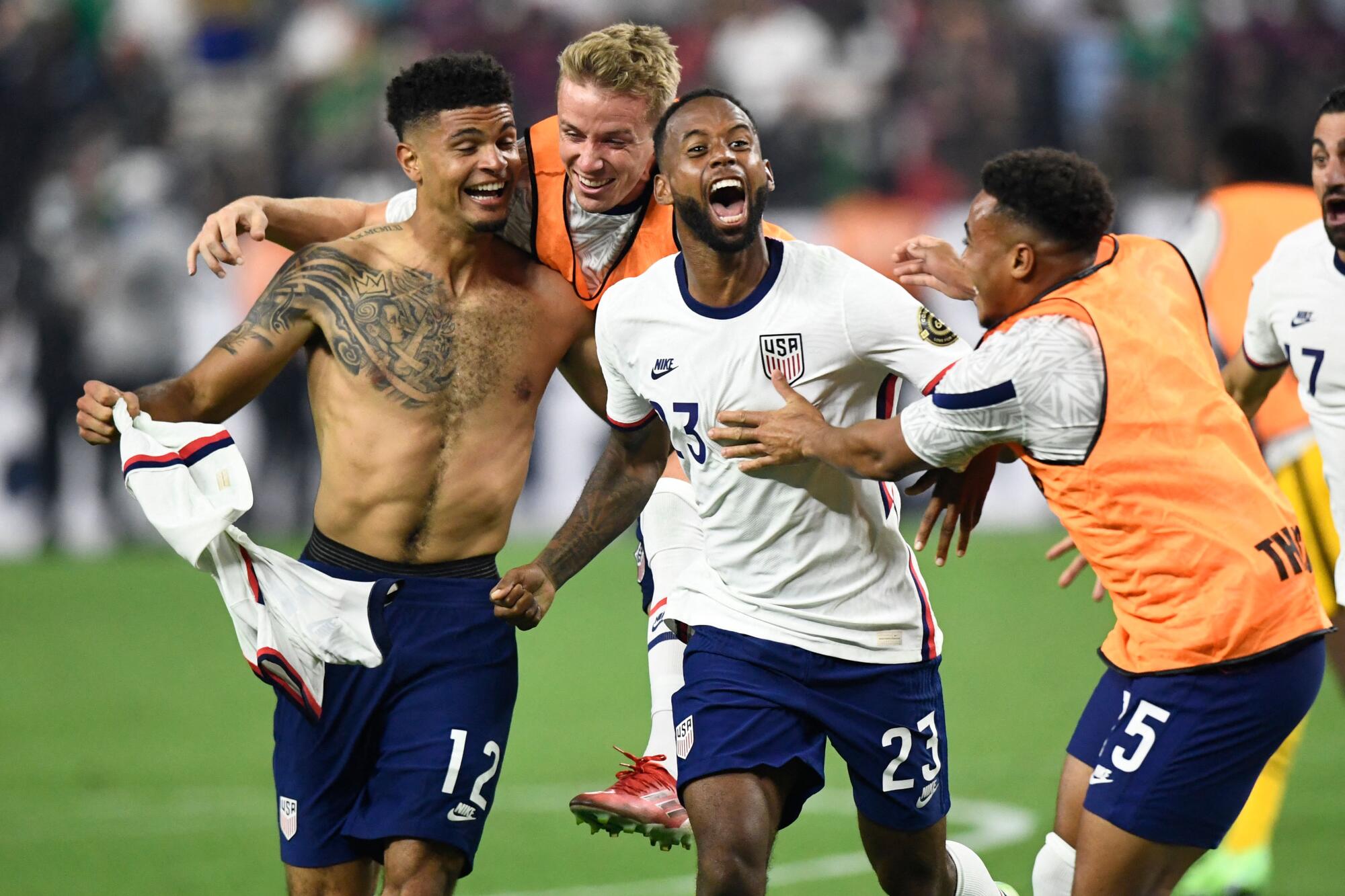USA's defender Miles Robinson (L) celebrates 