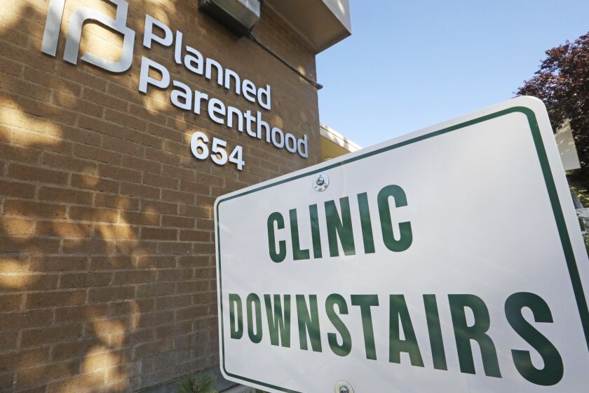 A sign is displayed at Planned Parenthood of Utah Wednesday, Aug. 21, 2019, in Salt Lake City. About 39,000 people received treatment from Planned Parenthood of Utah in 2018 under a federal family planning program called Title X. The organization this week announced it is pulling out of the program rather than abide by a new Trump administration rule prohibiting clinics from referring women for abortions. (AP Photo/Rick Bowmer)