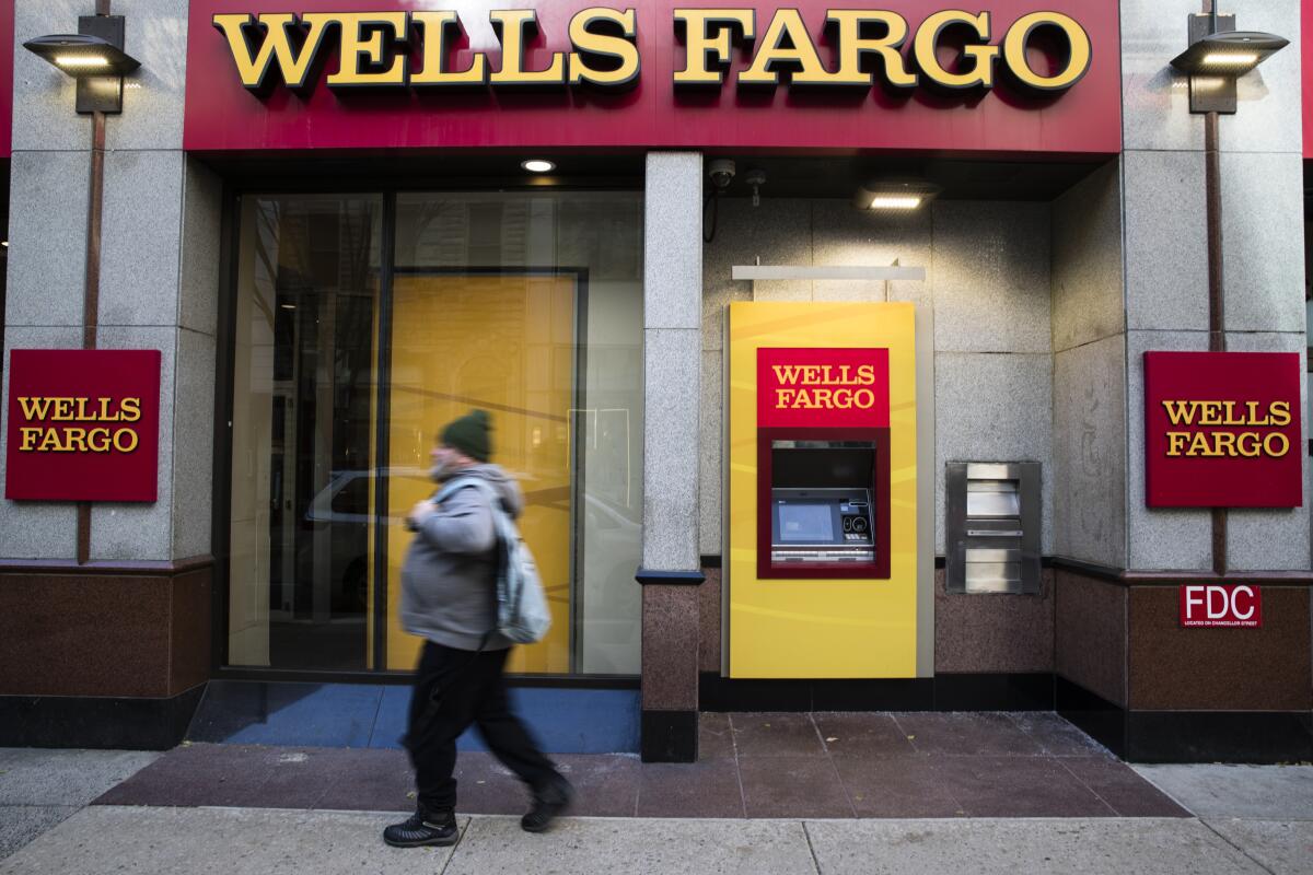 A man walks by a Wells Fargo bank  in Philadelphia. 