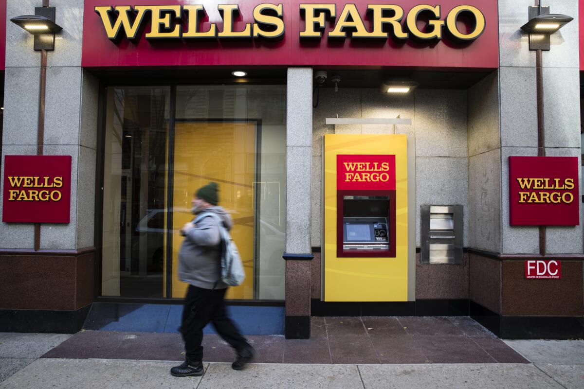 A man walks by a Wells Fargo bank in Philadelphia.