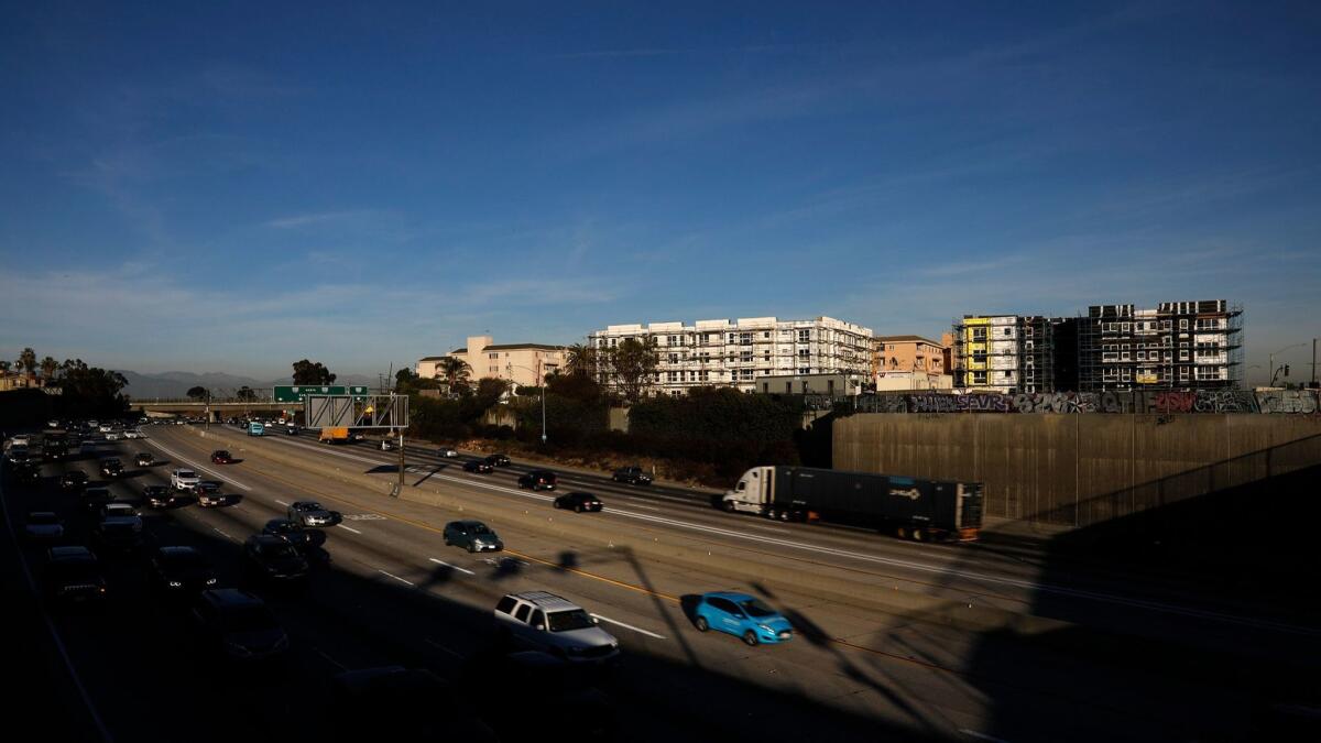 State cap-and-trade funds are being used to finance two affordable housing developments going up next to the 110 Freeway in L.A.'s Harbor Gateway neighborhood.