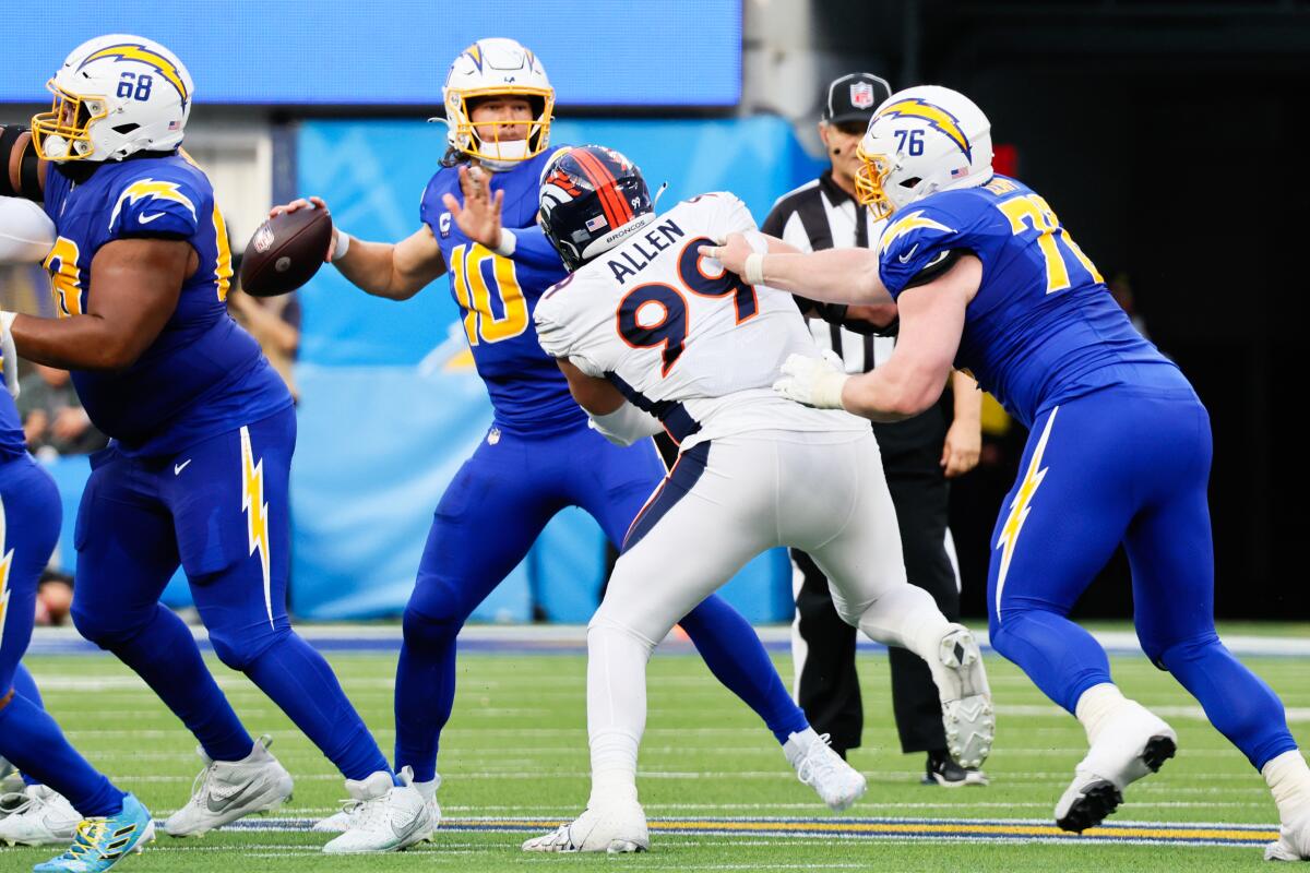 Chargers quarterback Justin Herbert looks to pass against the Denver Broncos in the first half Sunday.