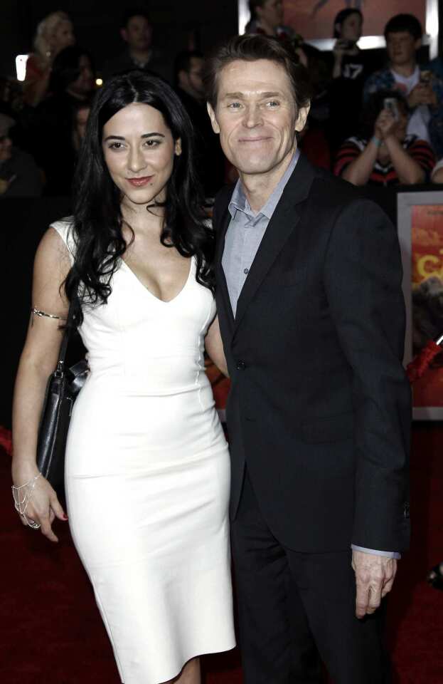 Willem Dafoe, who plays Tars Tarkas in the film, arrives with his wife, Giada Colagrande.