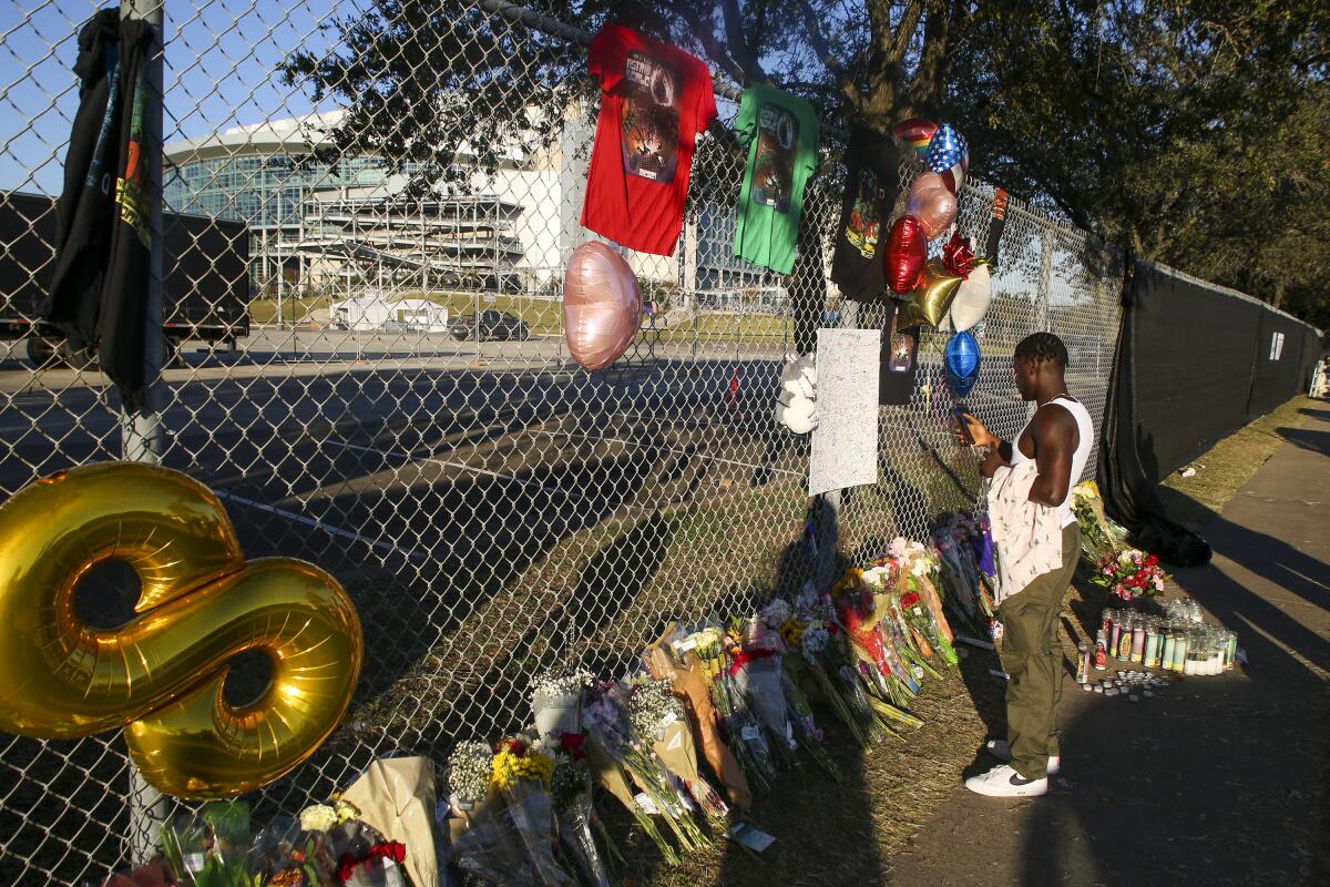 A man visits a makeshift memorial at the NRG Park grounds.