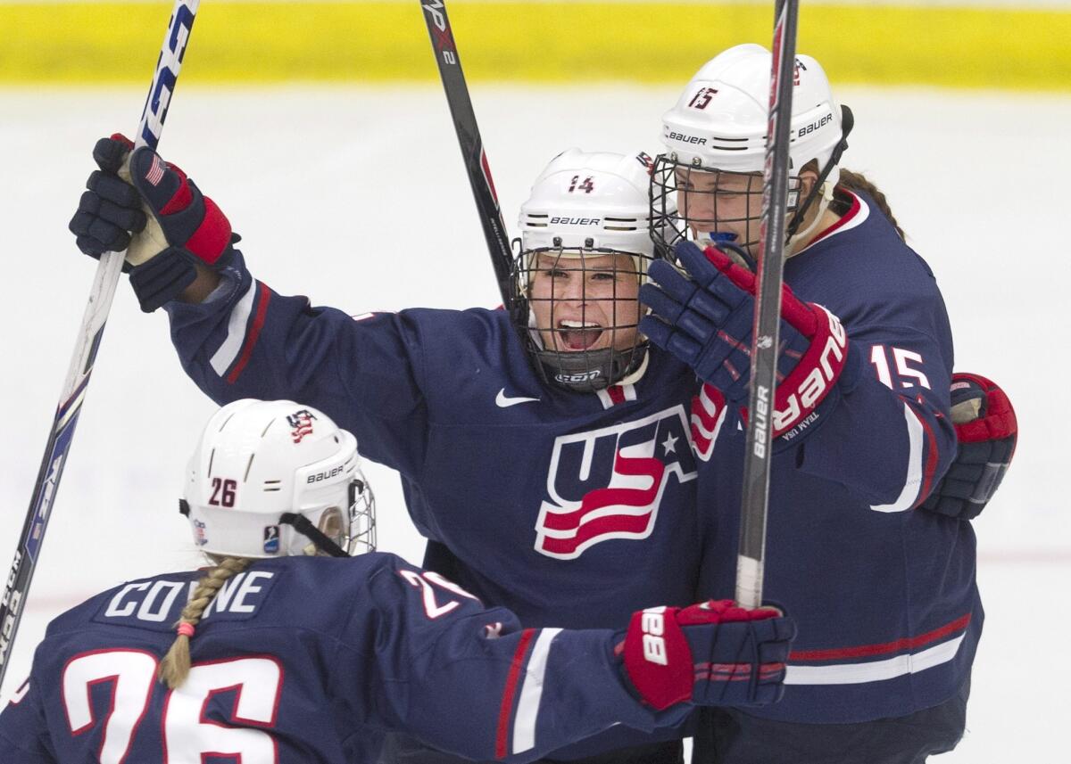 Brianna Decker, center, celebrates with teammates Kendall Coyne, left, and Anne Schleper after scoring a goal during the United States' 5-1 win over Canada on Thursday.