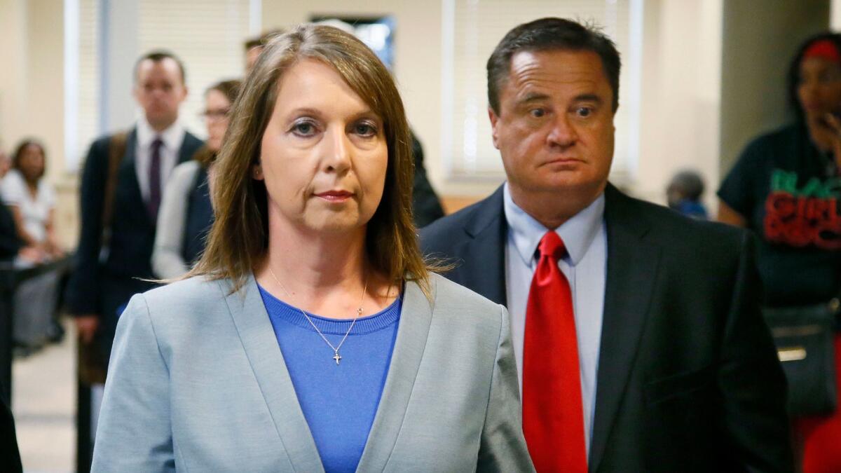Betty Jo Shelby leaves court with her husband, Dave Shelby, after the jury in her case began deliberations in Tulsa, Okla.