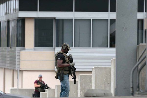 Police officers search Santa Monica College for a gunman.