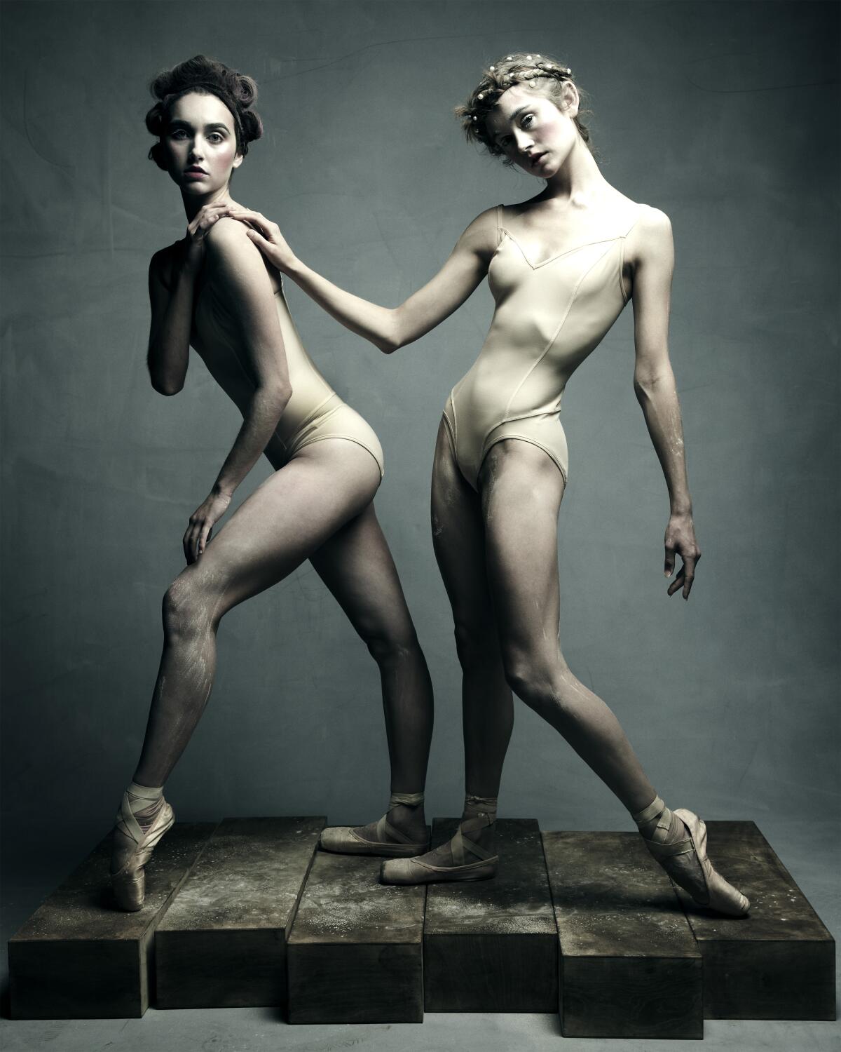 Two ballet dancers in nude leotards.