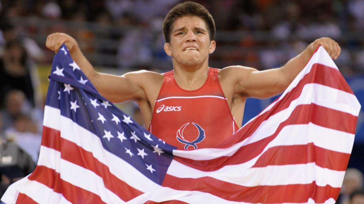Henry Cejudo celebrates after defeating Japan's Tomohiro Matsunaga for Olympic gold in 2008.