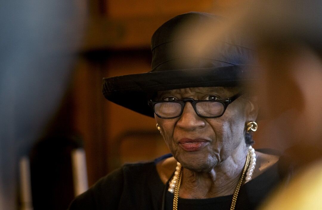 Bobbe Akalonu, 86, leads the meeting of the caregiver support group