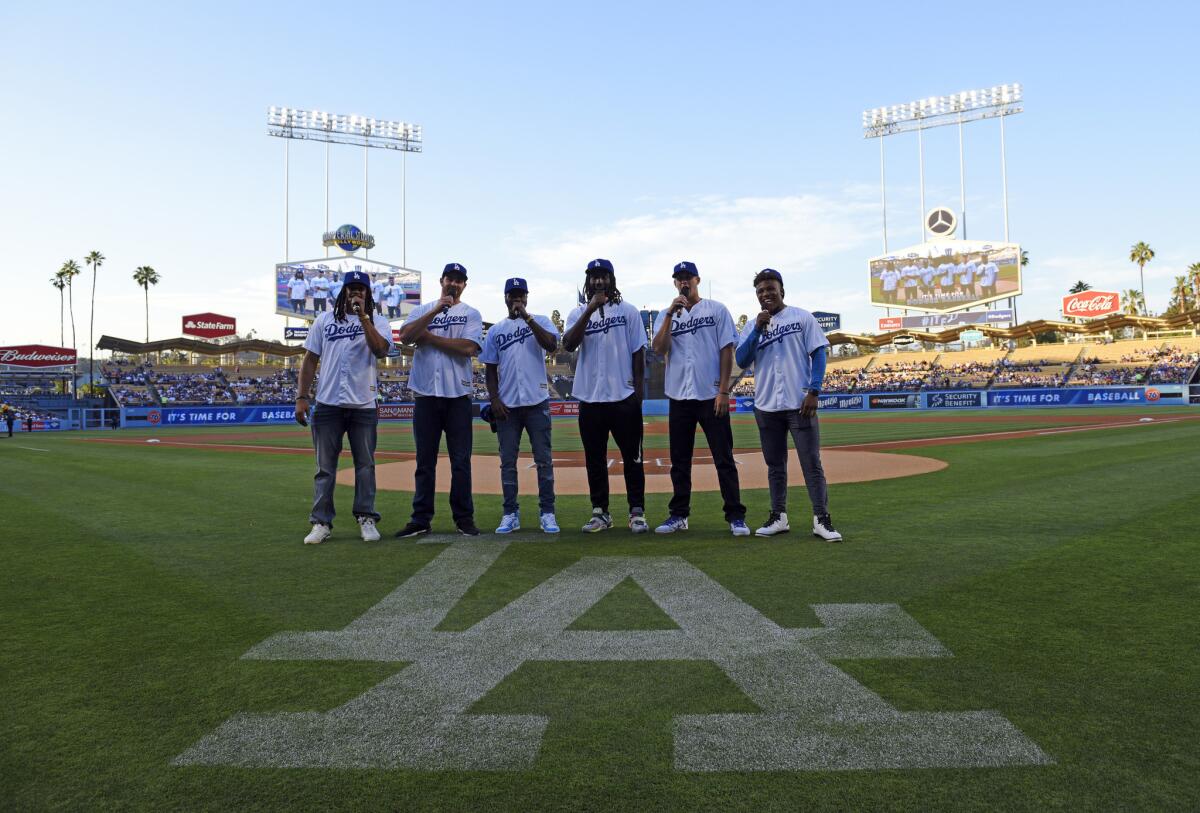 Rams 2016 draft picks Josh Forrest, left, Tyler Higbee, Michael Thomas, Temarrick Hemingway, Jared Goff and Pharoh Cooper announce the beginning of a Dodgers game against the Colorado Rockies on June 6.