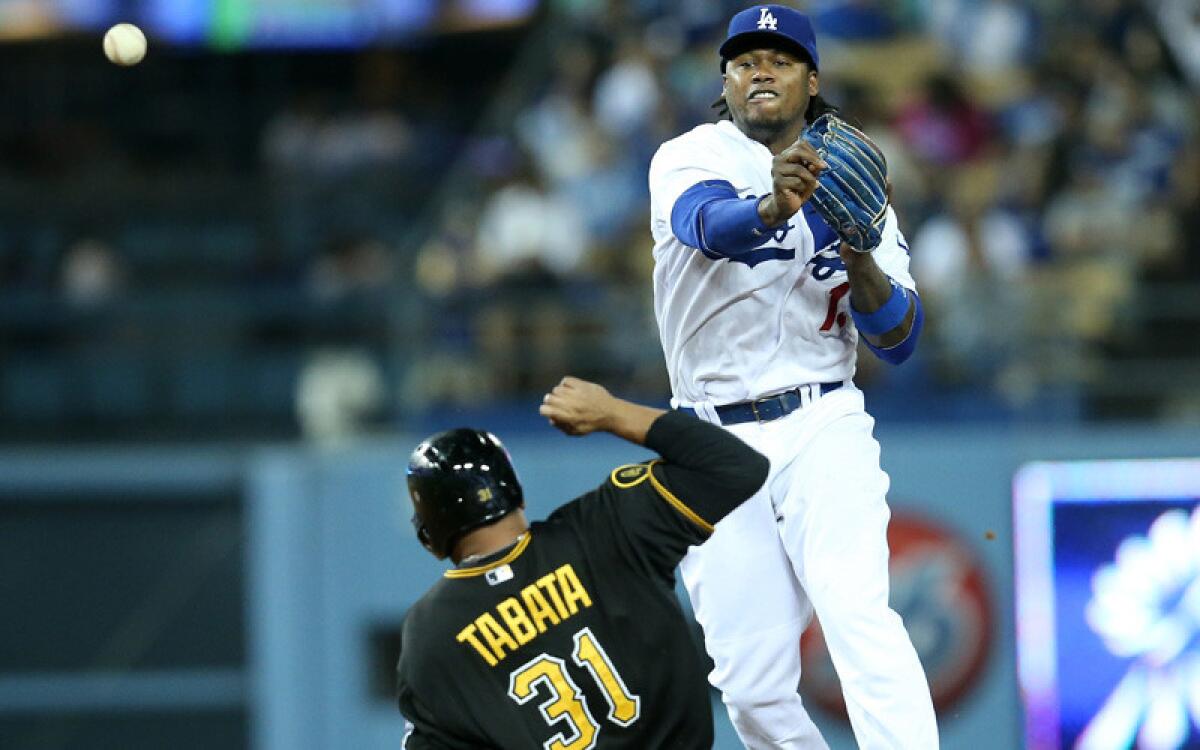 Dodgers shortstop Hanley Ramirez throws to first base to complete a double play after forcing out Pittsburgh's Jose Tabata in the eighth inning Friday night at Dodger Stadium.