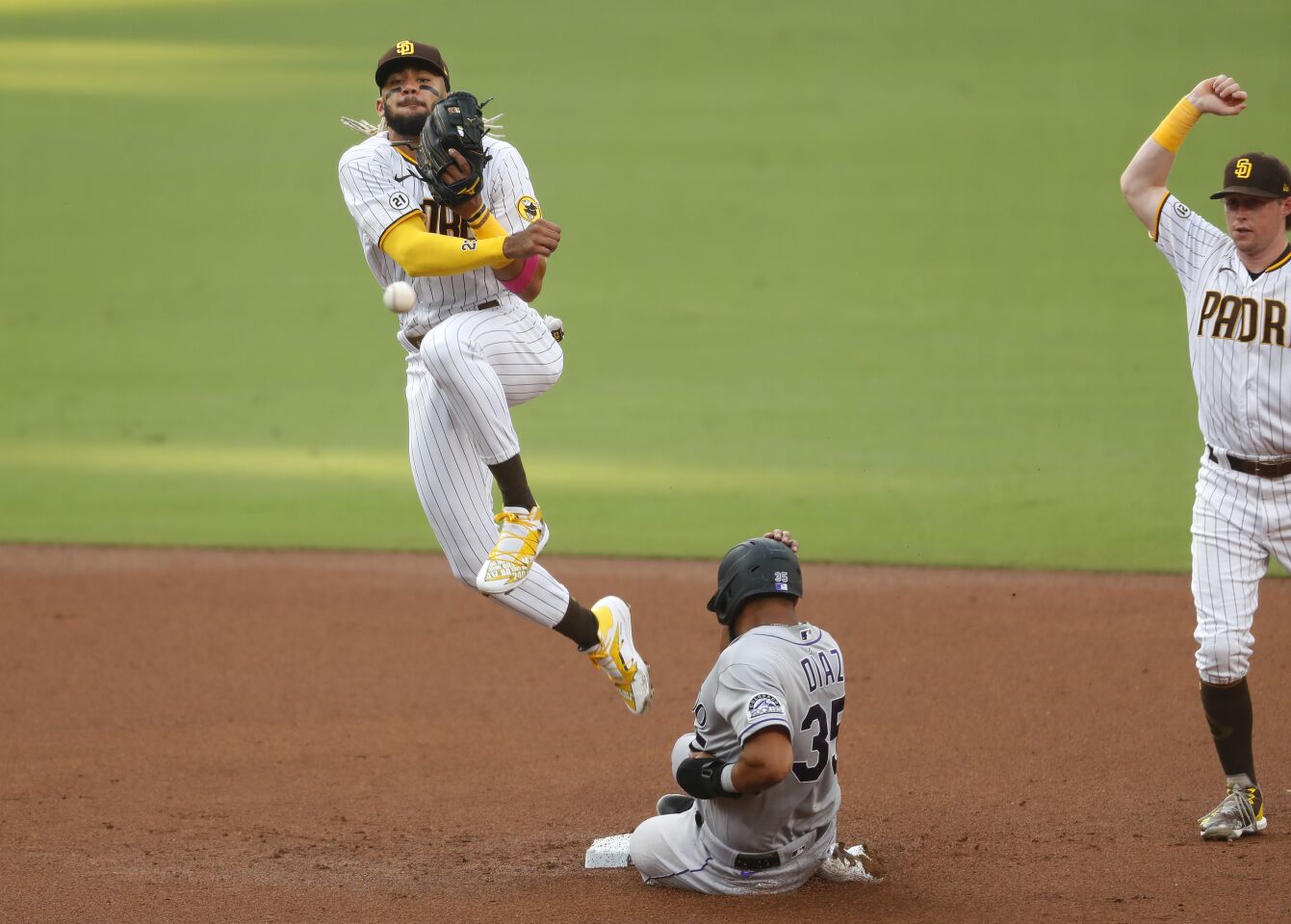 San Diego Padres Fernando Tatis Jr. forces out Elias Diaz of the Colorado Rockies as Raimel Tapia is safe at first base in the 3rd inning on Wednesday, Sept. 9, 2020.