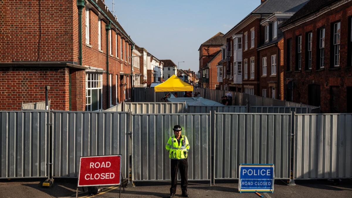 A police officer stands at a now restricted area on July 5, 2018, in a housing project in Salisbury, England, after Britain declared a major incident related to exposure to the deadly nerve agent Novichok.