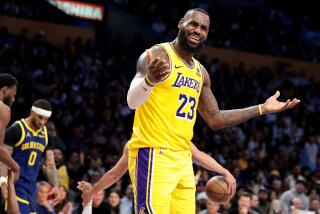 The Lakers' LeBron James raises his arms and disputes a call during a loss to the Warriors Tuesday