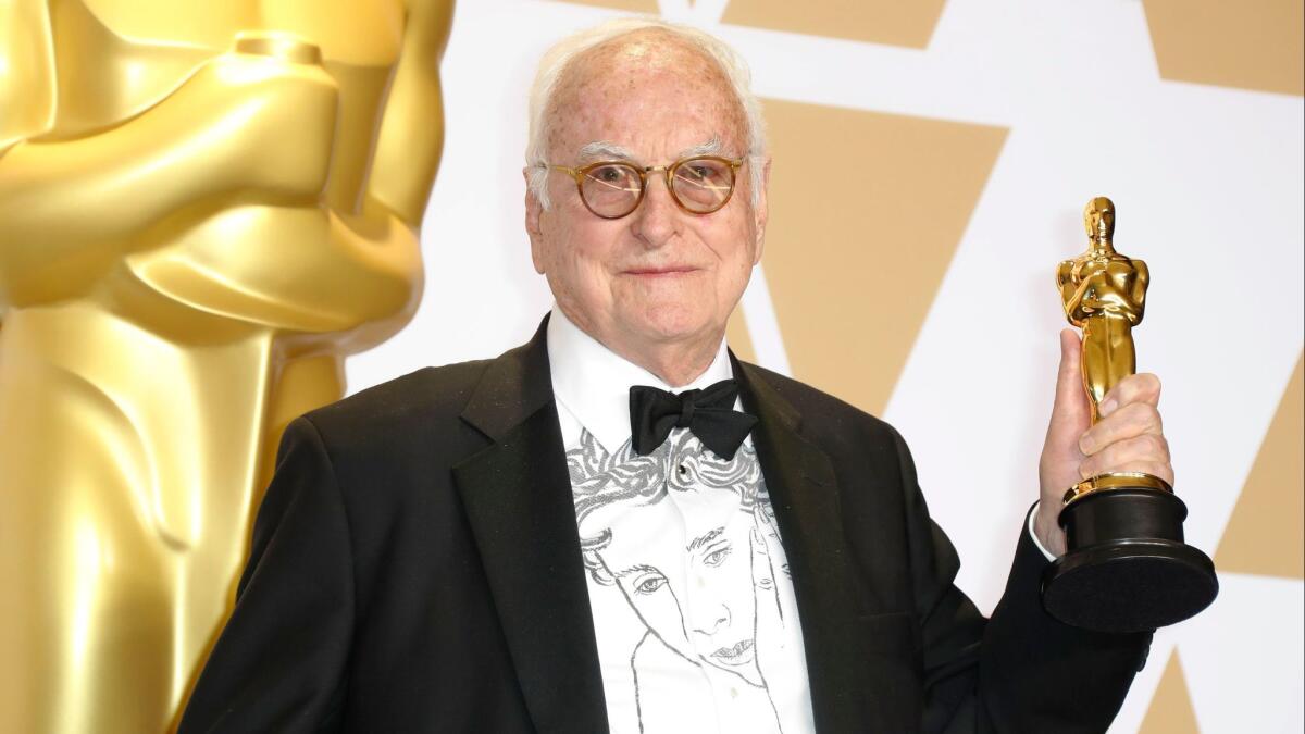 James Ivory displays his Oscar for adapted screenplay -- "Call Me by Your Name" -- in the press room. His shirt is emblazoned with an image of Timothée Chalamet in the movie.
